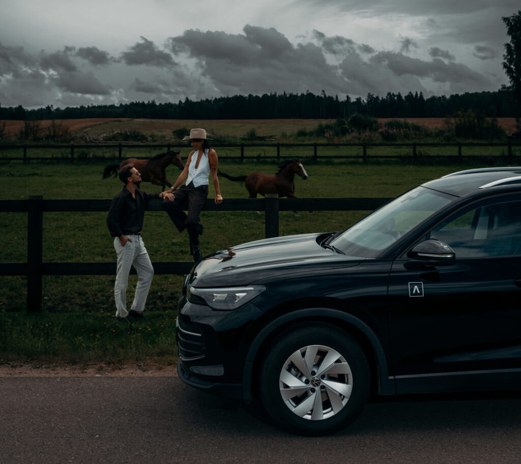 ADMITA car rental vehicle in countryside near horses