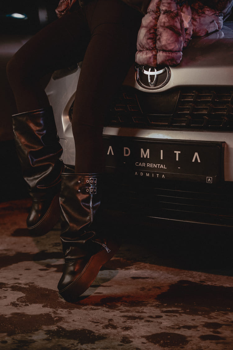 Person sitting on an ADMITA rental car – reliable car rental service abroad